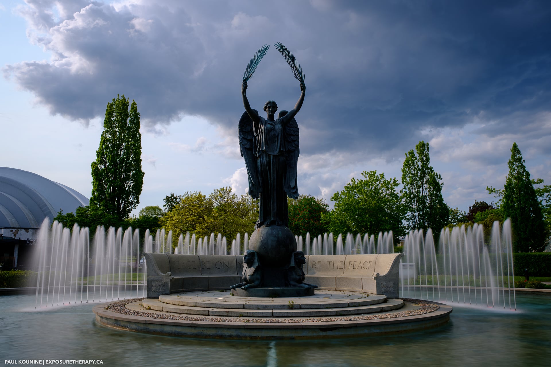 Long exposure of the Shrine Peace Memorial at Exhibition Place in Toronto on a sunny day with clouds in the background.